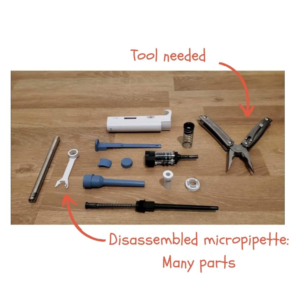 a disassembled micropipette with many spare parts and tools